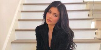 Kylie Jenner sitting on the stairs