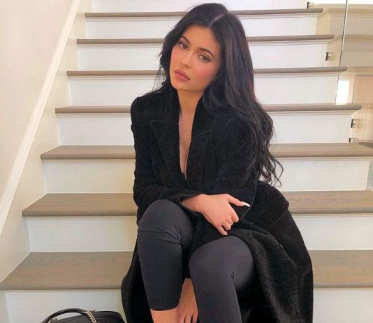 Kylie Jenner sitting on the stairs