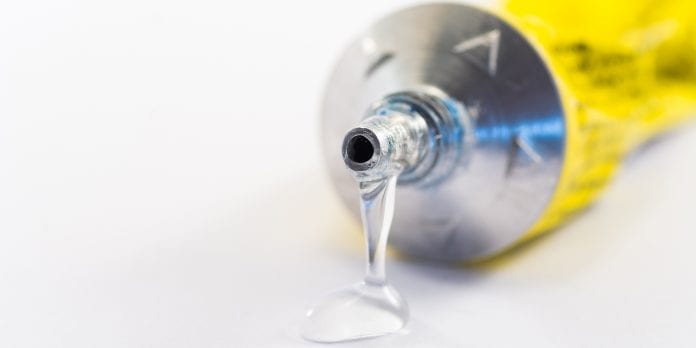 Glue coming out of the tube (white background)