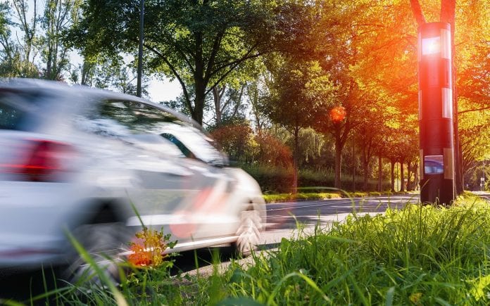 car drives into a radar trap, safe road traffic concept image