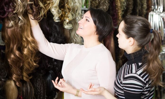 seller helping a customer with buying the right hair extensions