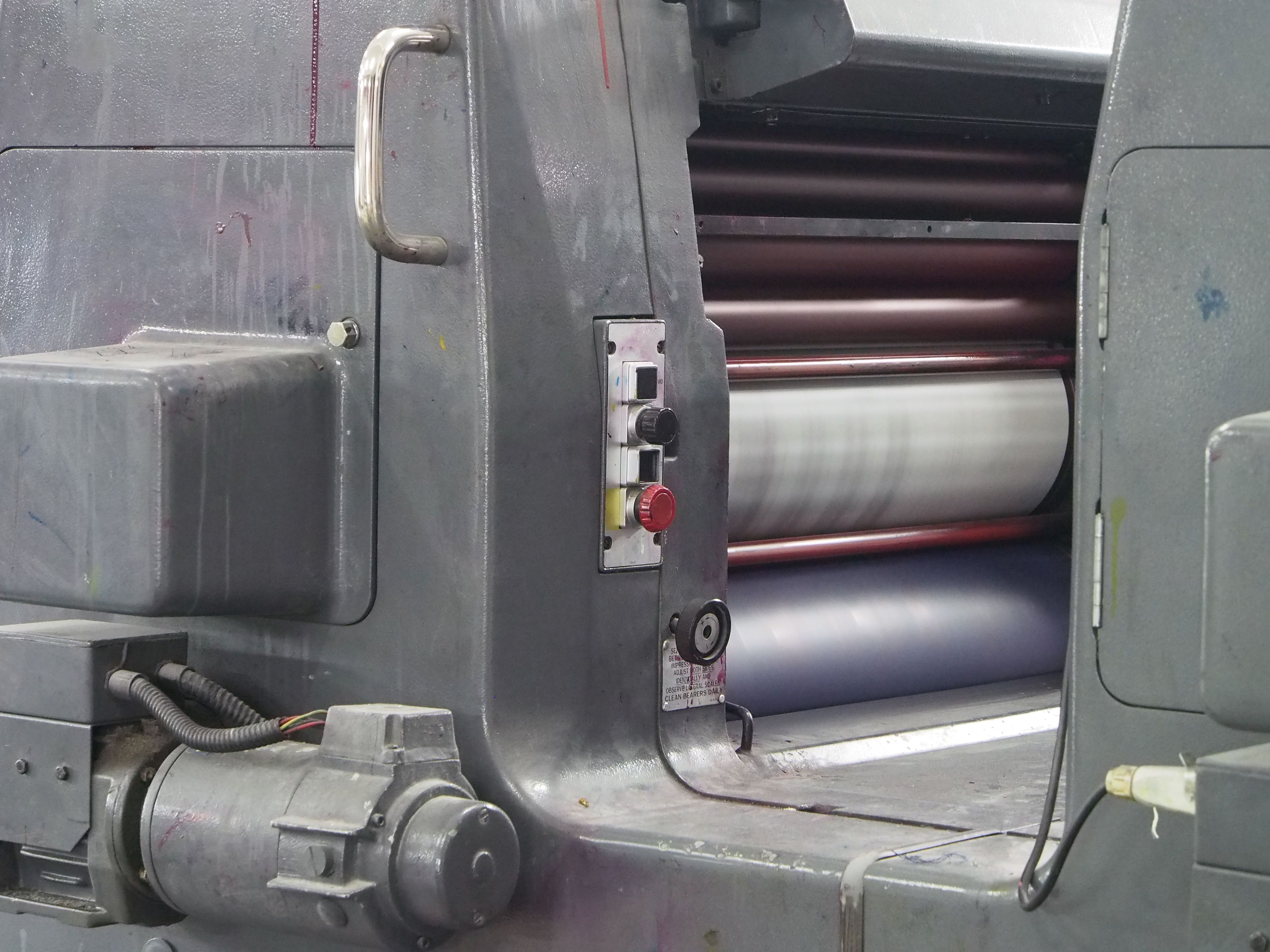 Industrial printing press printing custom artwork onto flexible mylar packaging film