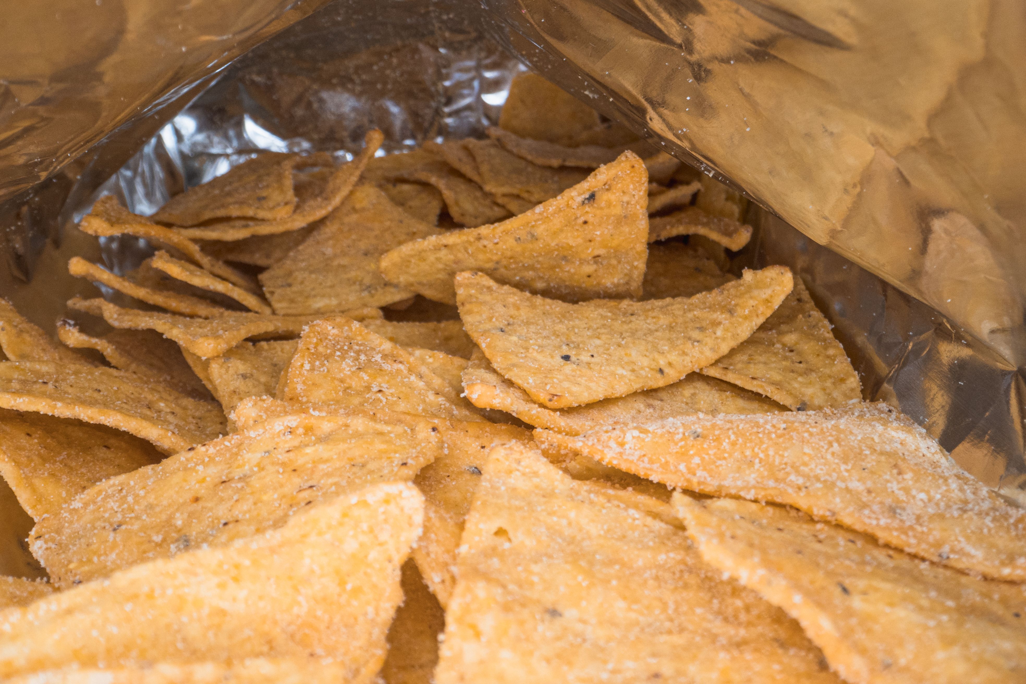 Snack food in an open metallic foil mylar bag showing barrier packaging in real-world use