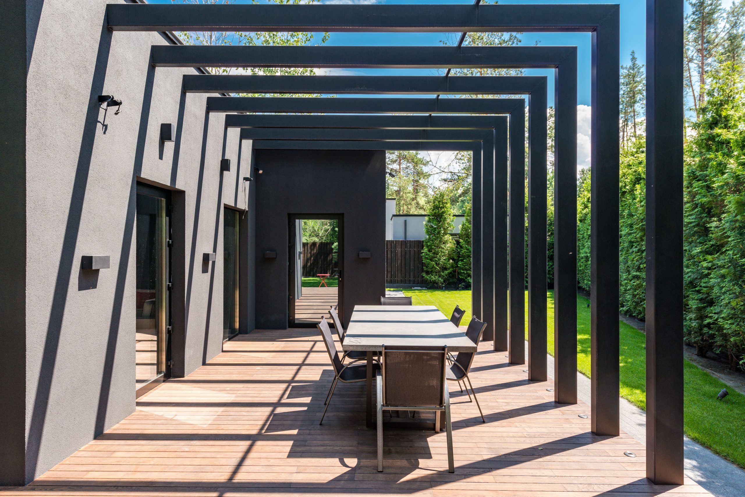Contemporary backyard patio with a pergola and outdoor dining furniture